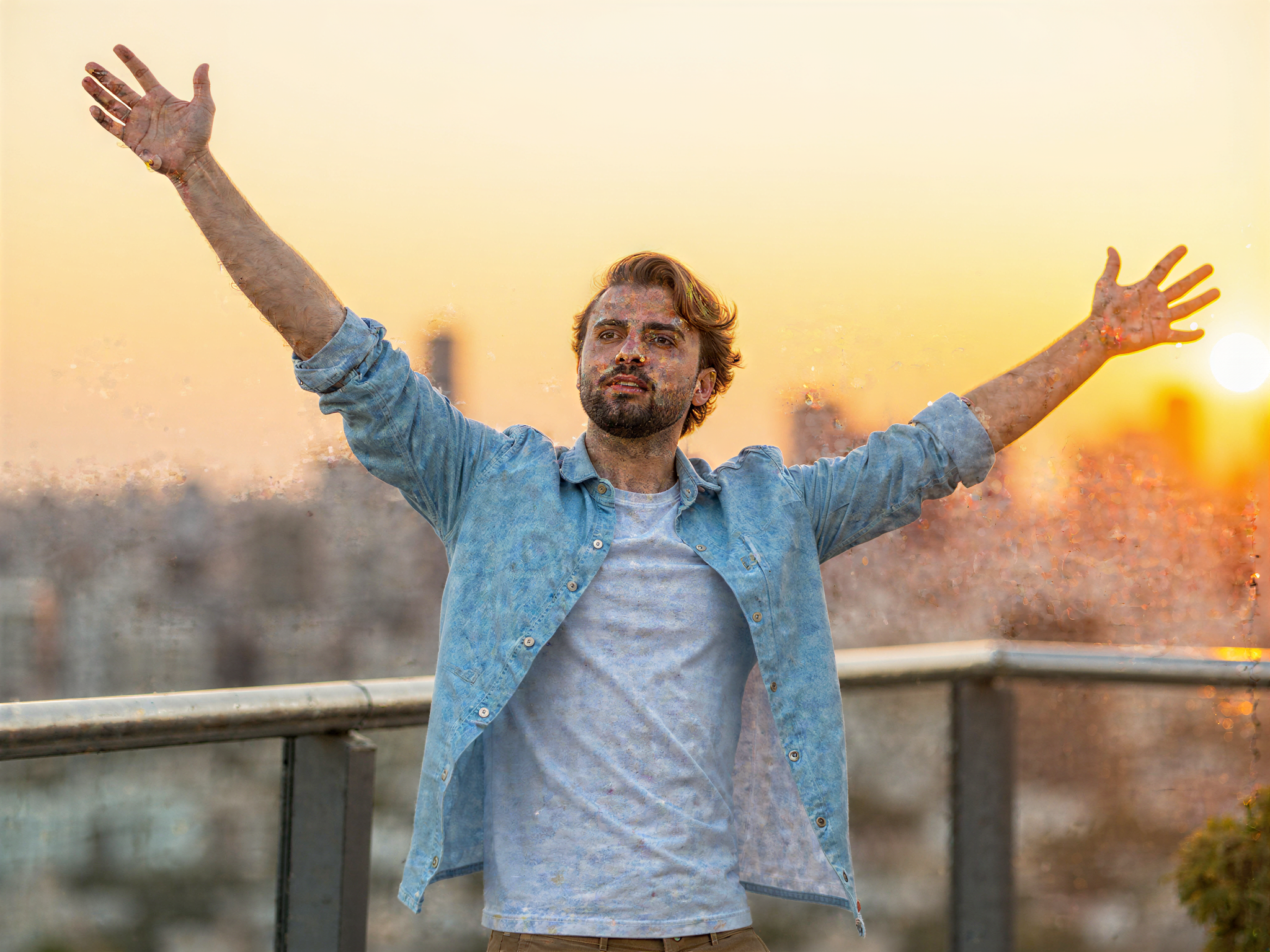 A 32-year-old male, OD62S, is captured in a vibrant, candid moment at Incheon, radiating joy. He stands in front of the scenic backdrop of the Incheon skyline at sunset, wearing a relaxed-fit linen shirt in a soft azure and stylish khaki shorts. His arms are raised in a carefree gesture, embodying the happiness of the moment, as a charming smile lights up his face. The warm golden hour light beautifully highlights his features, creating a soft glow that enhances the positive vibe. The composition uses the rule of thirds to balance the subject against the picturesque cityscape, conveying a harmonious sense of freedom and joy in an urban environment.